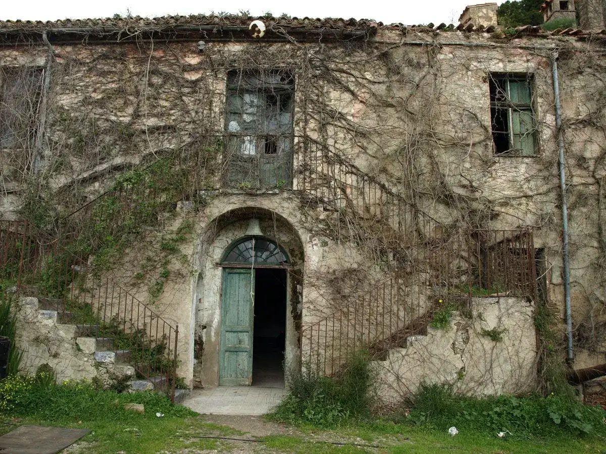 Antica casa in rovina in Sardegna, ricoperta di edera. Un'opportunità per chi cerca case a 1 euro.