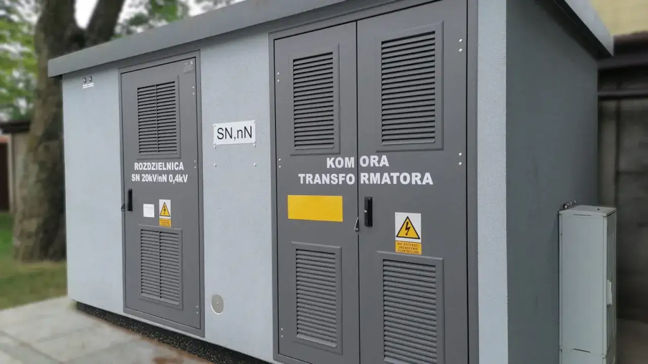 Szara stacja transformatorowa z drzwiami oznaczonymi