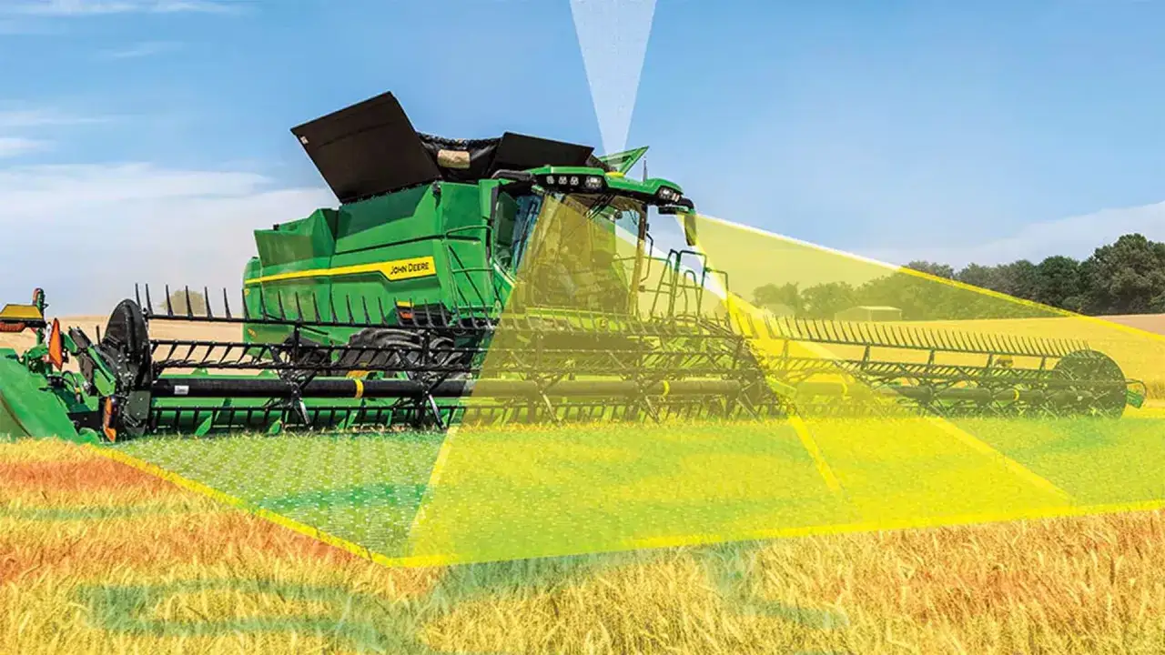 A green John Deere combine harvester in a wheat field, with digital overlays showing data collection for digital farming.