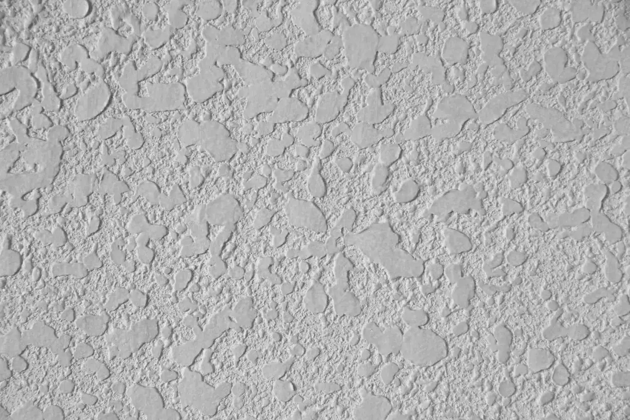 Close-up of a textured ceiling, showing the bumpy, irregular pattern created when learning how to texture a ceiling.
