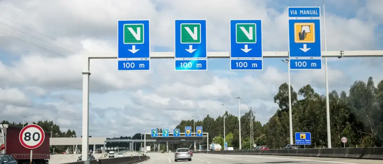 Autobahn in Portugal mit Fahrspuren, die sich in 100m trennen. Ein Schild zeigt ein Tempolimit von 80.