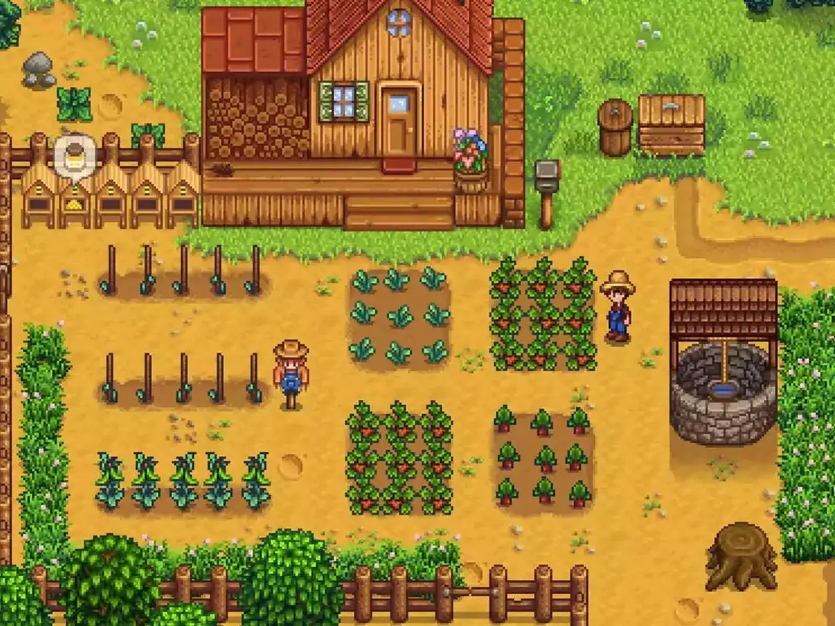 Una granja de Stardew Valley con cultivos, colmenas y un pozo. ¡Un buen lugar para empezar tu guía!