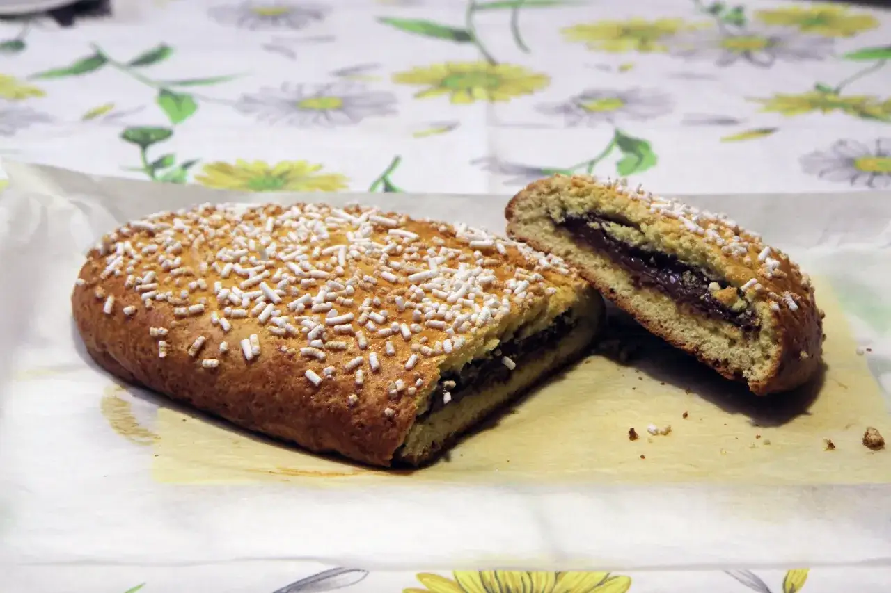 Ciambellone marchigiano ripieno di Nutella, cosparso di zuccherini. Un dolce che sa di casa e di festa.