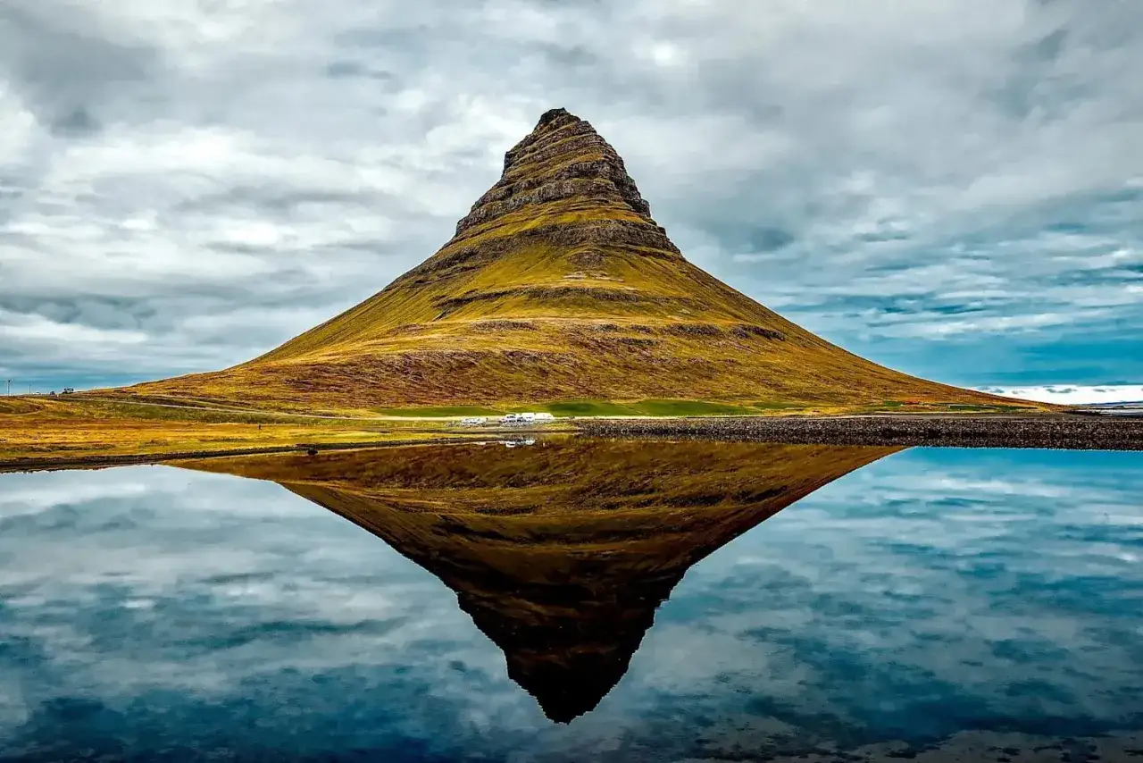 Ikona Islandii, Kirkjufell, odbija się w spokojnej wodzie. To jeden z najpiękniejszych g&oacute;r w Europie.
