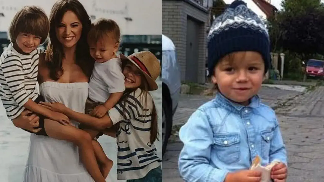Uśmiechnięta mama z dziećmi, w tym z Janem B. w czapce, i chłopiec w dżinsowej koszuli.