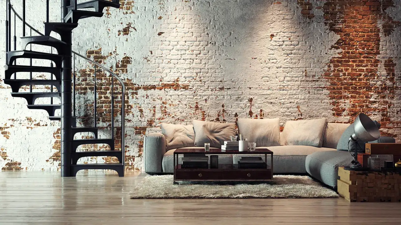 Nowoczesny salon z ceglaną ścianą i krętymi schodami. Wygodna sofa i stolik kawowy tworzą przytulny zestaw mebli loft.