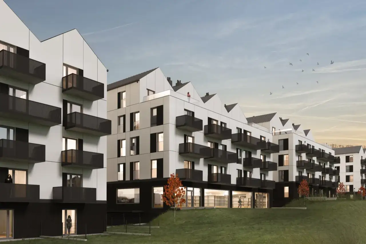 Nowoczesne mieszkanie od dewelopera w budynku z tarasami i balkonami. Architektura z charakterystycznymi, spiczastymi dachami.