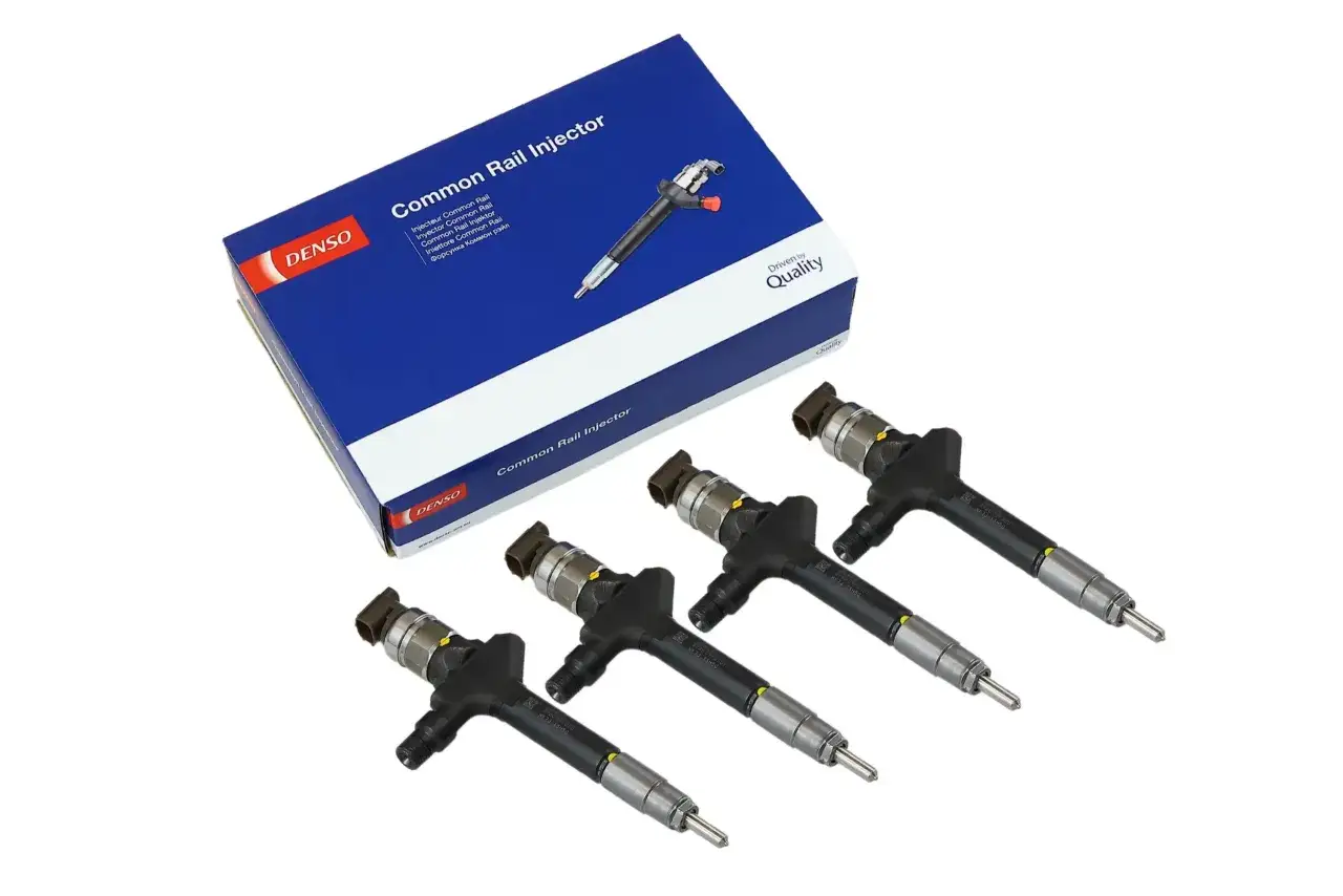 Cztery wtryskiwacze Denso Common Rail, idealne do Volvo 2.4 D5. Zapakowane w niebieskie pudełko z logo producenta.