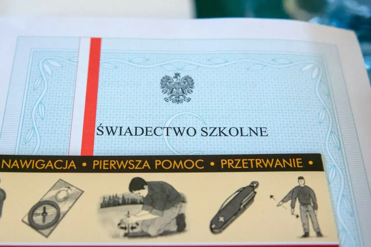 Świadectwo szkolne z godłem Polski. Czy w klasie 1-3 są świadectwa z paskiem? Na dole widać ilustracje: nawigacja, pierwsza pomoc, przetrwanie.