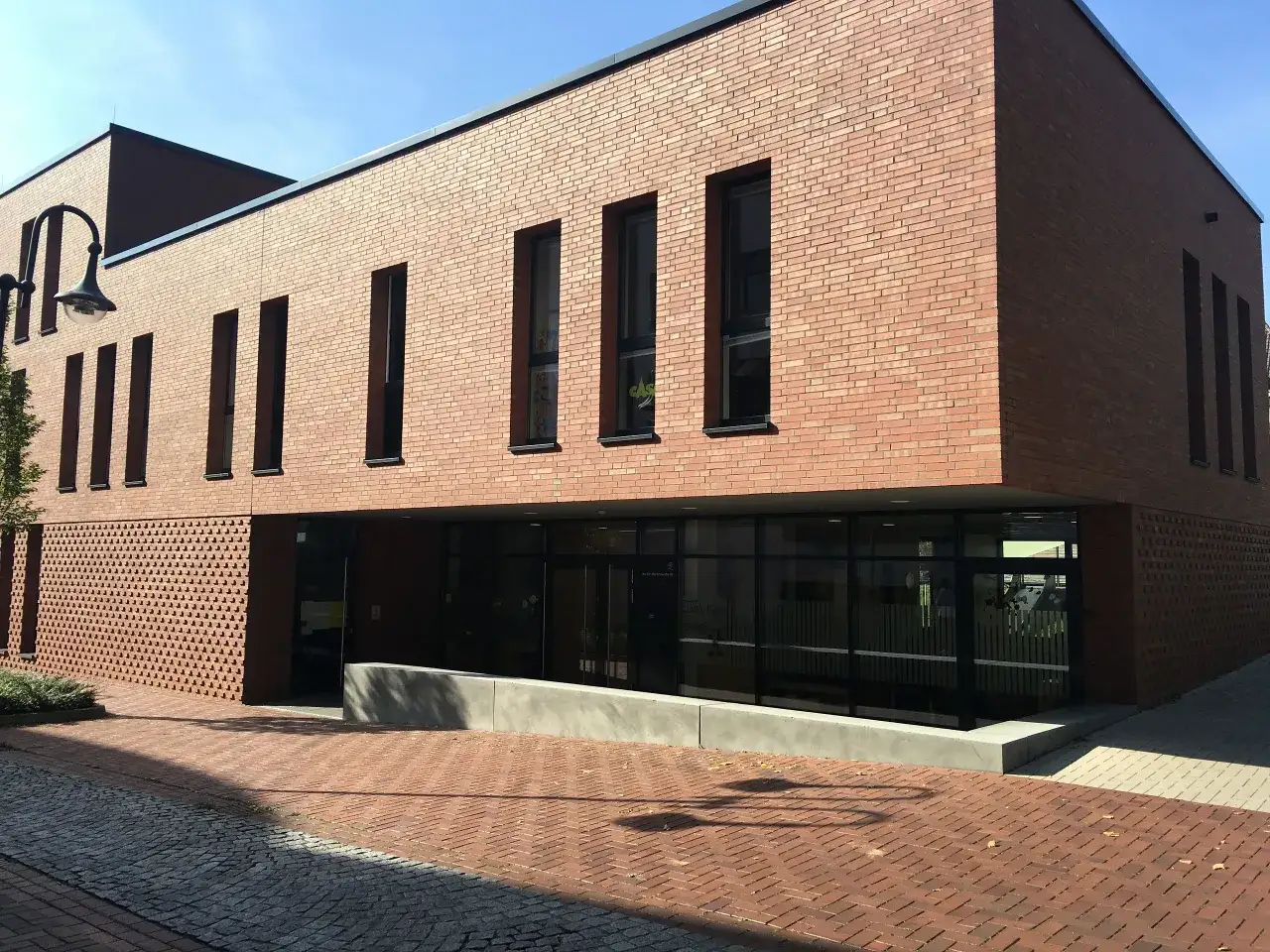 Modernes Gebäude mit roten Ziegeln und großen Fenstern in der Bottrop Altstadt.