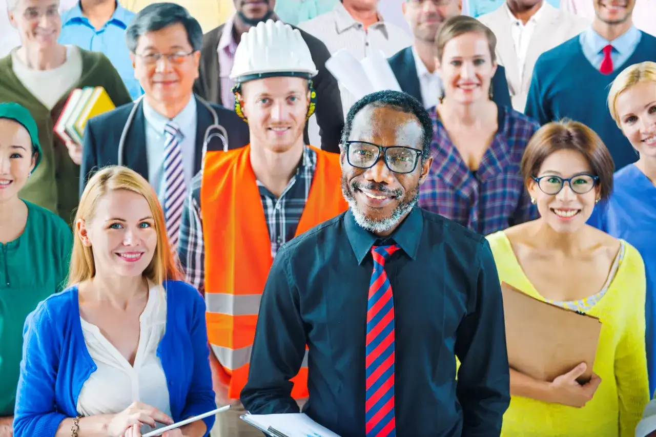 A diverse group of smiling people from various professions and backgrounds. This image shows why diversity is important in society, bringing together different perspectives and talents.