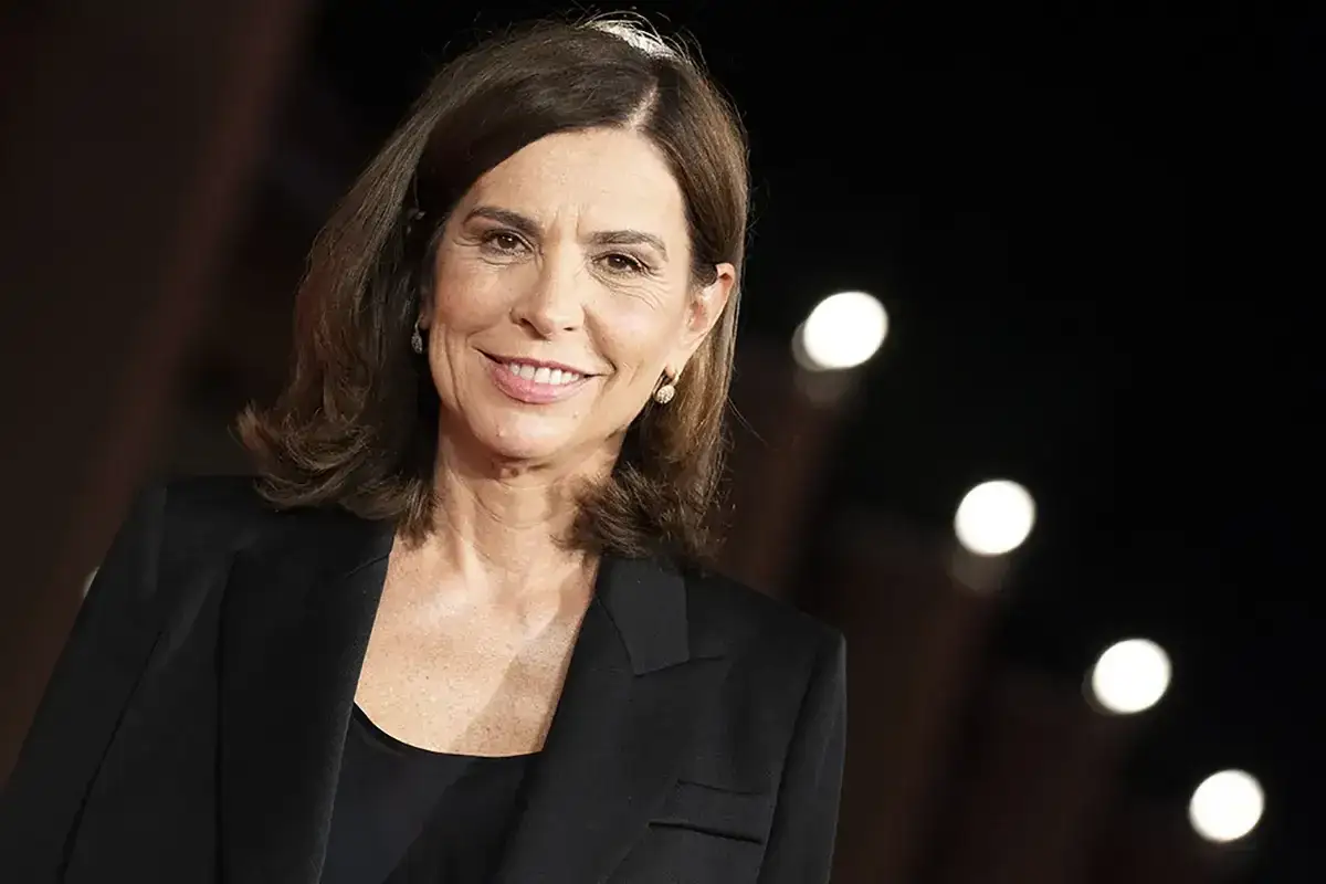 Ritratto di una donna sorridente con un blazer nero, un esempio di registe donne che ispirano.