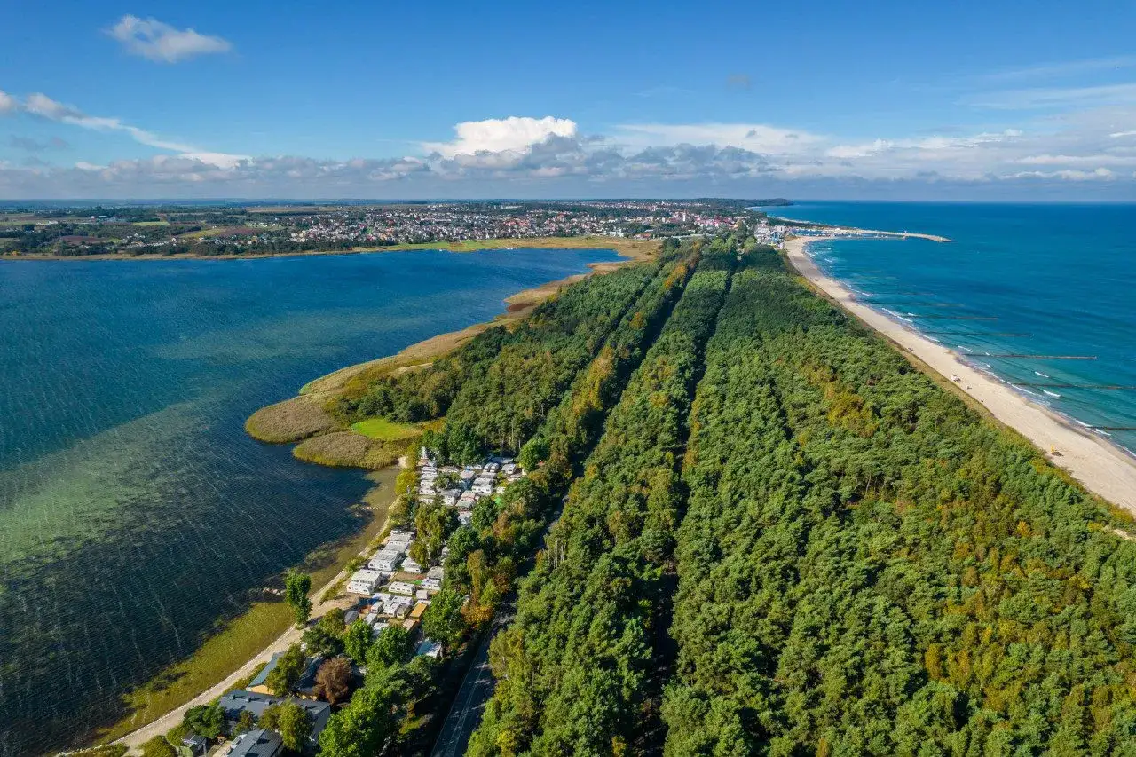 Widok z lotu ptaka na Półwysep Helski, z kempingiem i lasem sosnowym wzdłuż plaży.