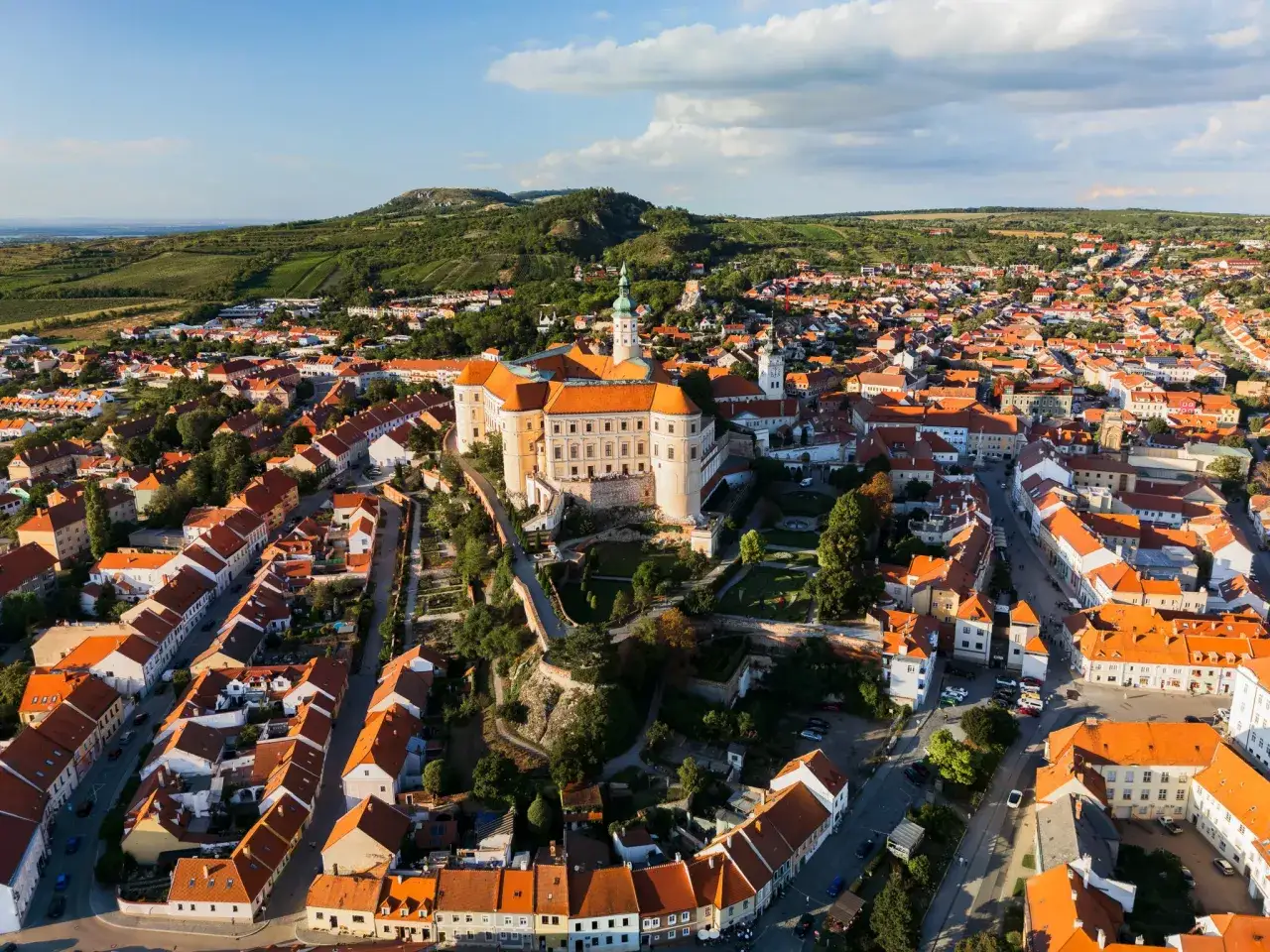 Malowniczy widok na zamek i miasteczko, idealne na weekend w Czechach. Winnice na wzgórzach dodają uroku.