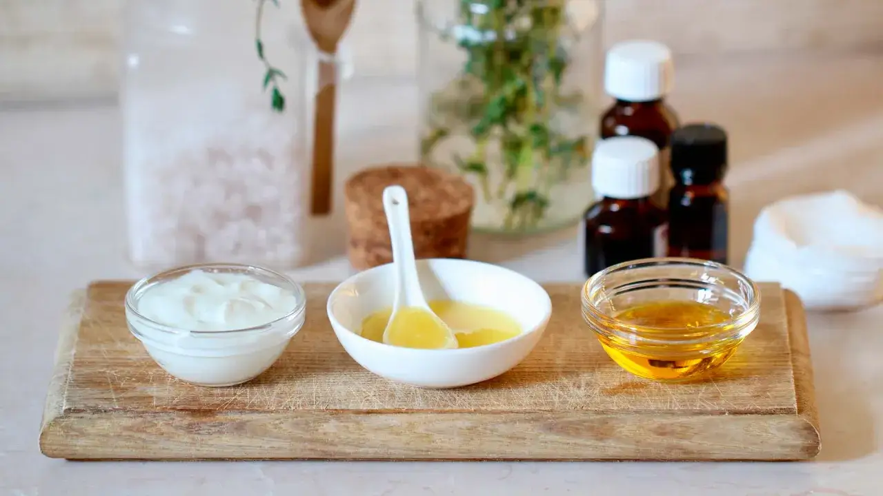 Natural ingredients for a foot detox soak: yogurt, oil, honey, Epsom salts, and essential oils. Learn how to remove toxins from feet naturally.