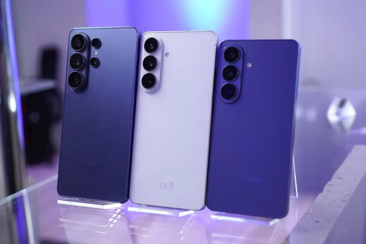 Trzy telefony Samsung Galaxy S26 w kolorach granatowym, jasnofioletowym i niebieskim, prezentujące swoje moduły aparatów.