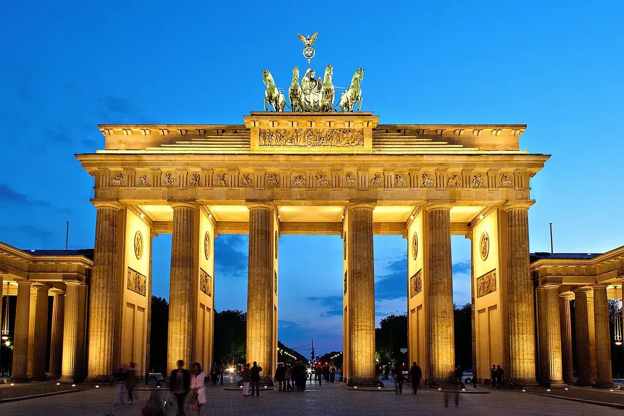 Brandenburger Tor i Berlin, upplyst p&aring; kv&auml;llen. Ett av Berlins m&aring;sten, med Quadrigan p&aring; toppen.