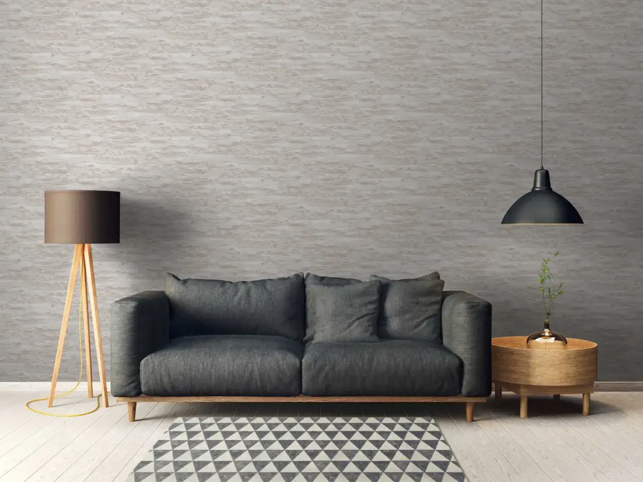 Modernes Wohnzimmer mit grauem Sofa, Stehlampe und Beistelltisch. Die Wand ist mit einer Tapete mit Steinoptik tapeziert, tapezieren ohne kleister ist hier die Lösung.