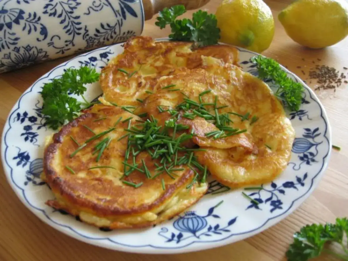 Herzhafte Kartoffelpuffer mit Schnittlauch, inspiriert von magerquark rezepte. Dazu frische Kr&auml;uter und Zitronen.