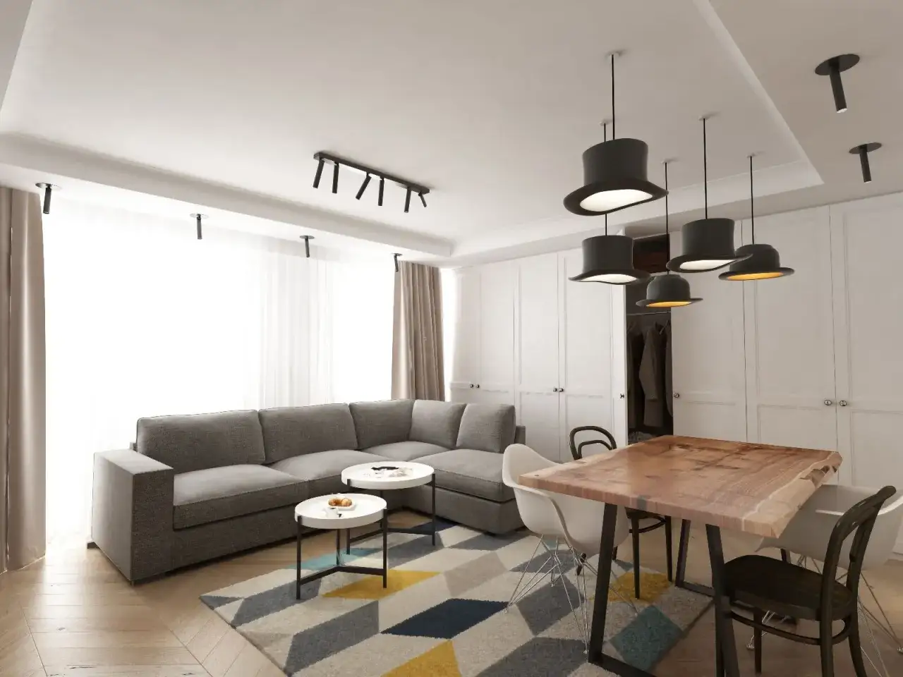 Nowoczesny salon z szarą kanapą, stolikami kawowymi i stołem z litego drewna. Inspiracja, jak umeblować salon, by był funkcjonalny i stylowy.