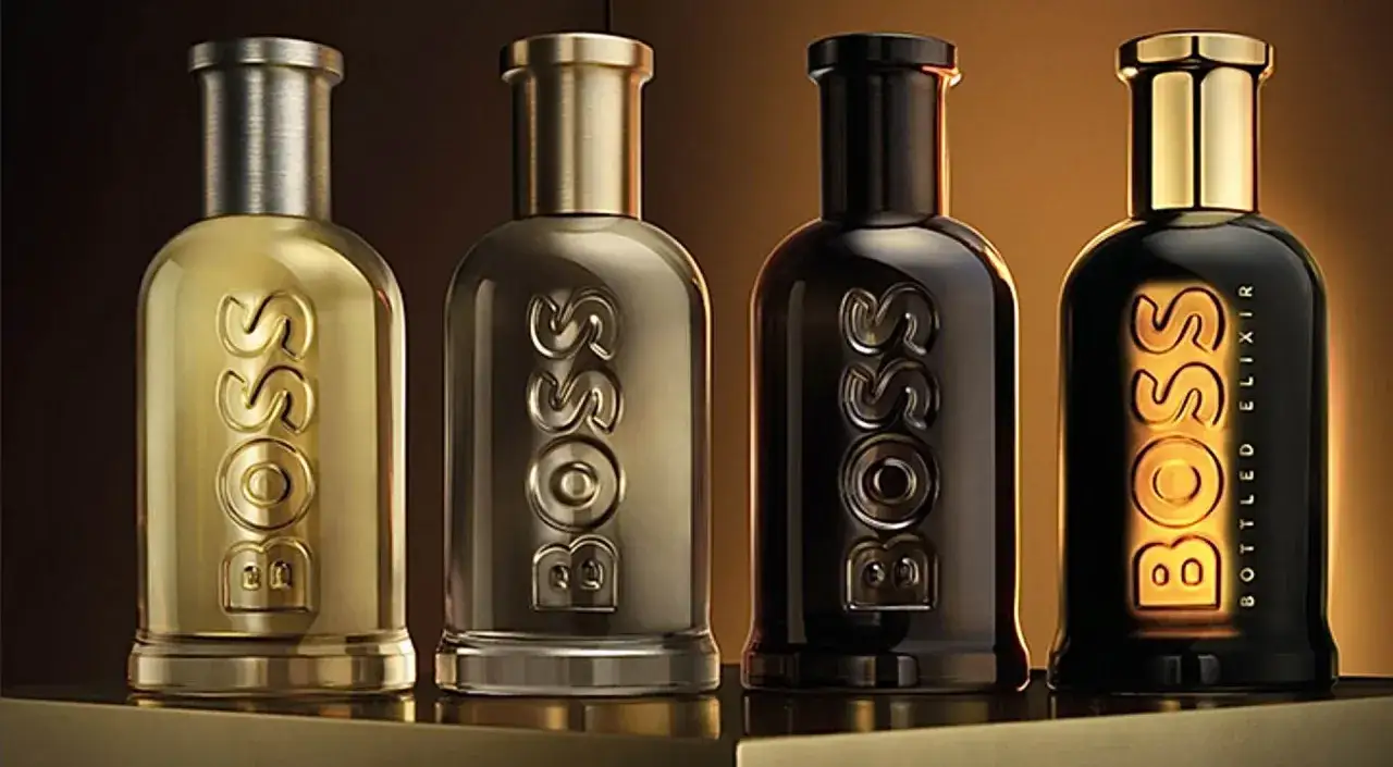 Cztery flakoniki perfum Hugo Boss. Złoty, dwa metaliczne i czarny z napisem 