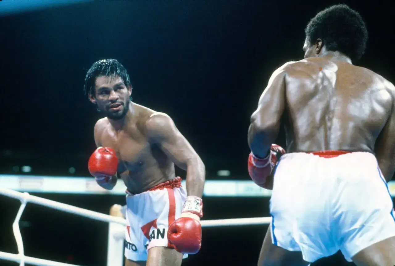 Roberto Duran, a legendary fighter, faces his opponent in the ring, both ready for battle.