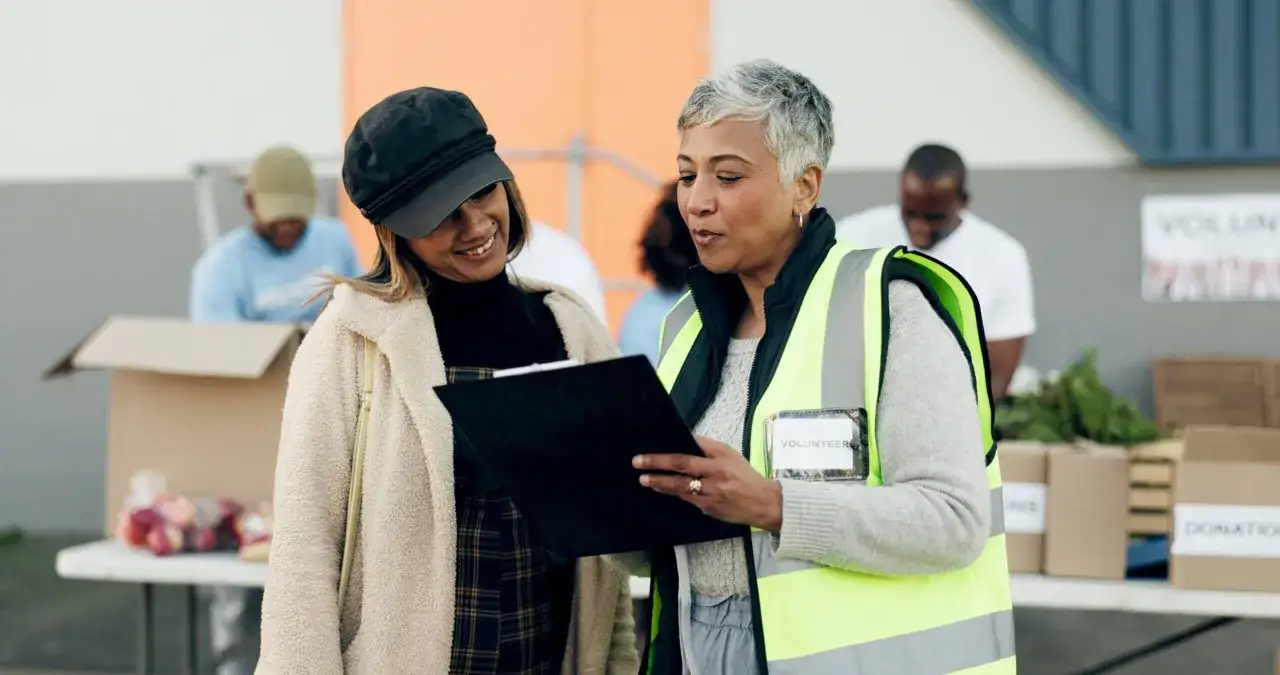 Volunteers review paperwork for non profit money management at a donation drive.