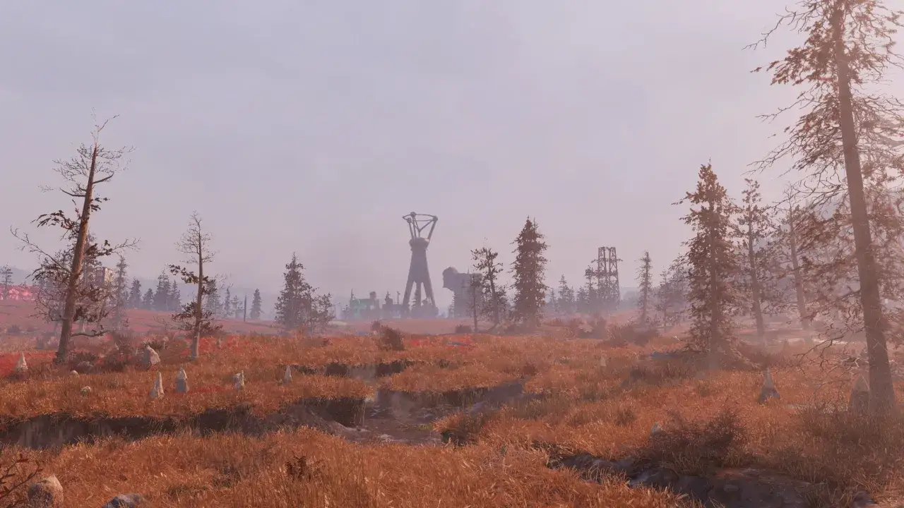 Pustkowie w najnowszym Fallout, z charakterystyczną wieżą i zniszczonymi budynkami w oddali.
