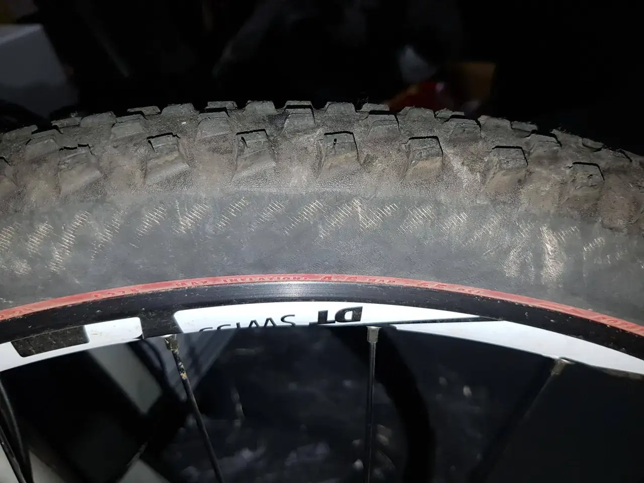 Worn mountain bike tire tread, showing how long do mountain bike tires last. The DT Swiss rim is visible.