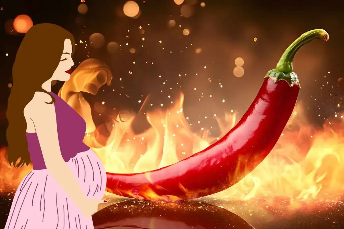Donna incinta con un peperoncino piccante, circondati da fiamme e scintille.