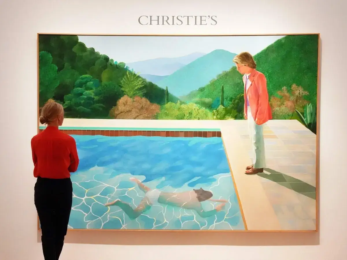 A woman in red observes David Hockney's
