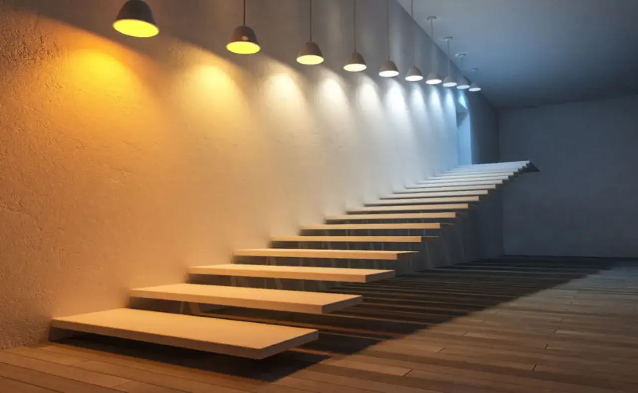 Escalera flotante con iluminaci&oacute;n que transita de blanco c&aacute;lido a blanco fr&iacute;o, creando un ambiente moderno y minimalista.