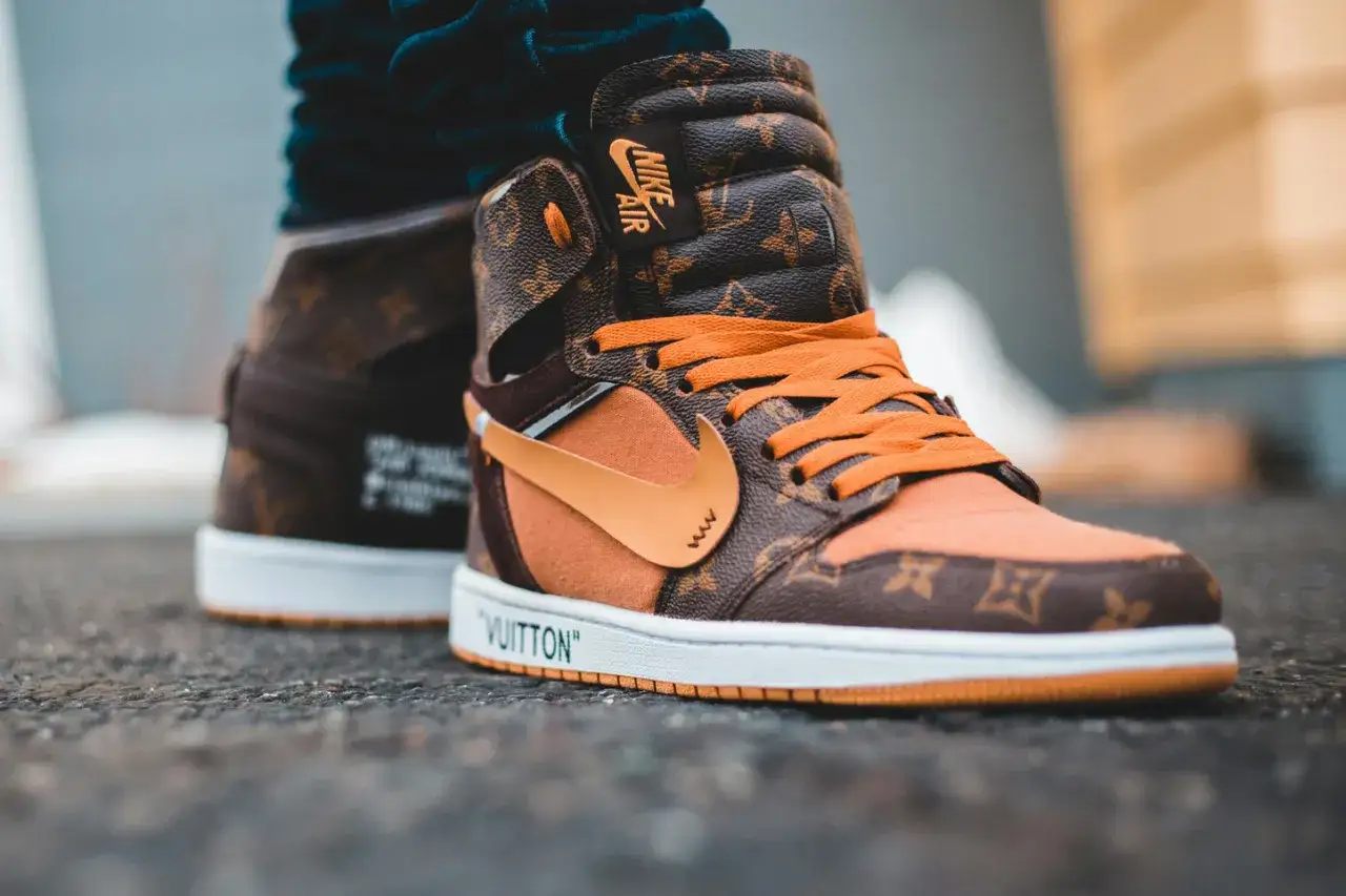 Pomarańczowo-brązowe sneakersy z monogramem Louis Vuitton i pomarańczowymi sznur&oacute;wkami, prawdopodobnie najdroższe buty na świecie.