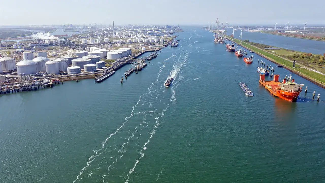 Großer Industriehafen mit Tanks, Schiffen und Windrädern. Ein geschäftiger