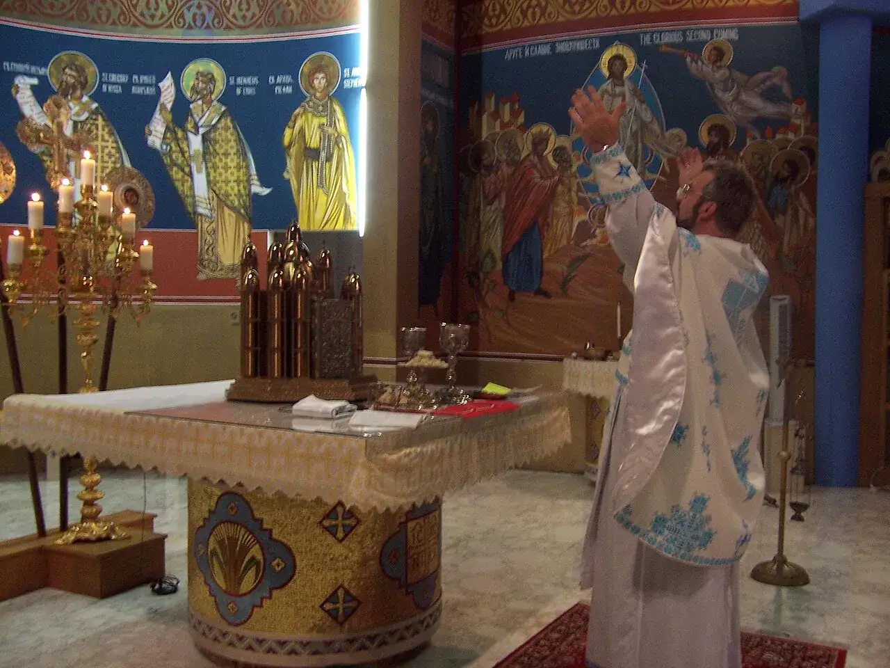 A priest leads a liturgy in an Orthodox church, with icons of saints and biblical scenes adorning the walls.