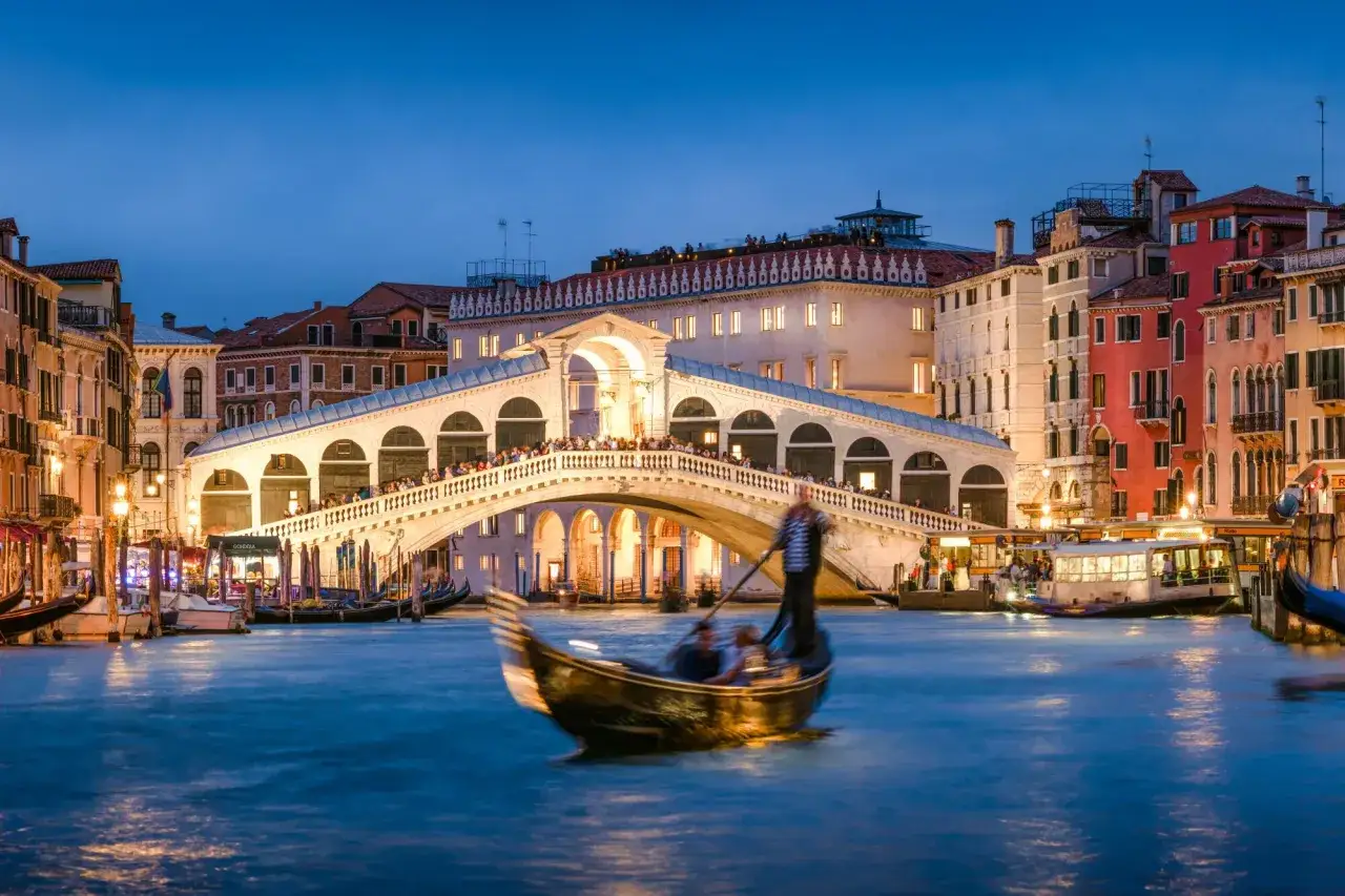 Gondola pod Mostem Rialto, wieczorem. Idealne miejsce, by poczuć magię Wenecji i zastanowić się, co robic w Wenecji.
