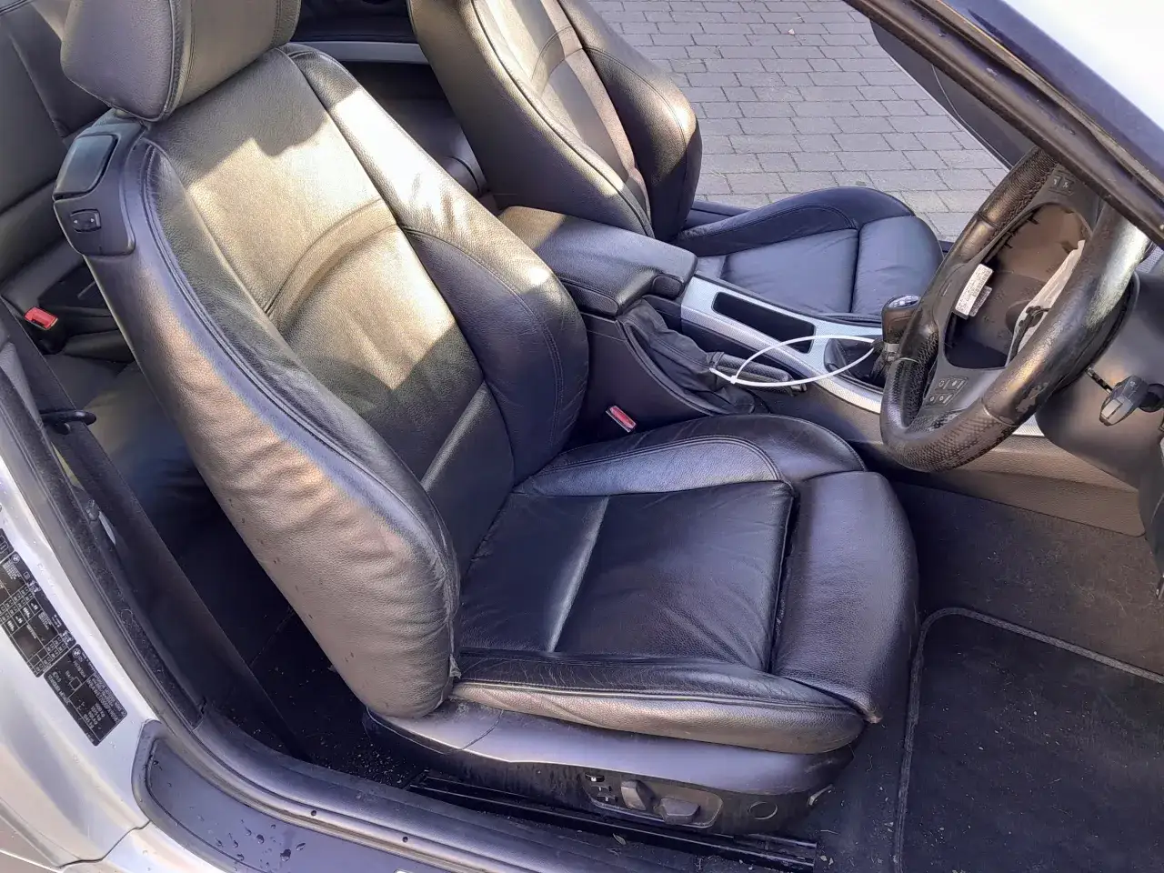 Skórzane fotele w BMW E46 Coupe M Pakiet. Widok od strony pasażera, z kierownicą i konsolą środkową.