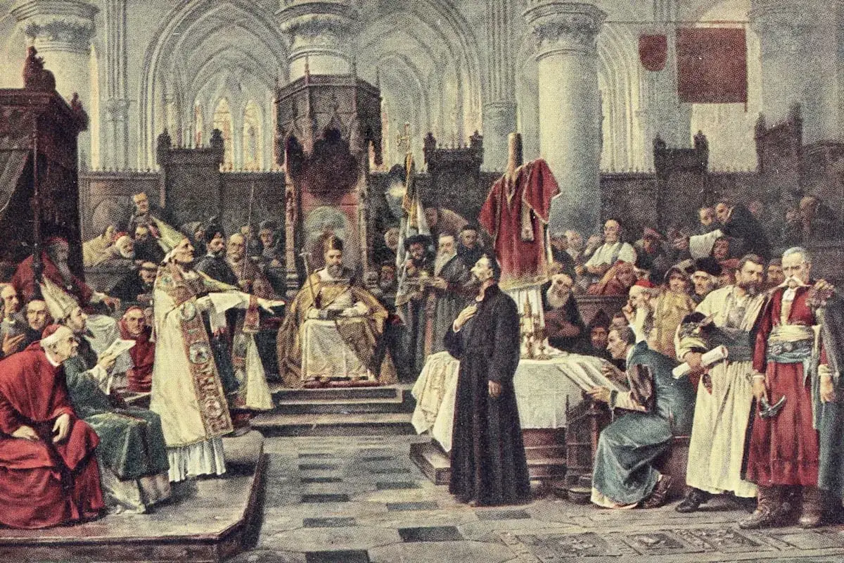 Jan Hus' Tag: Ein Mann in schwarzem Gewand steht vor einer Versammlung in einer Kathedrale, w&auml;hrend ein Bischof spricht.