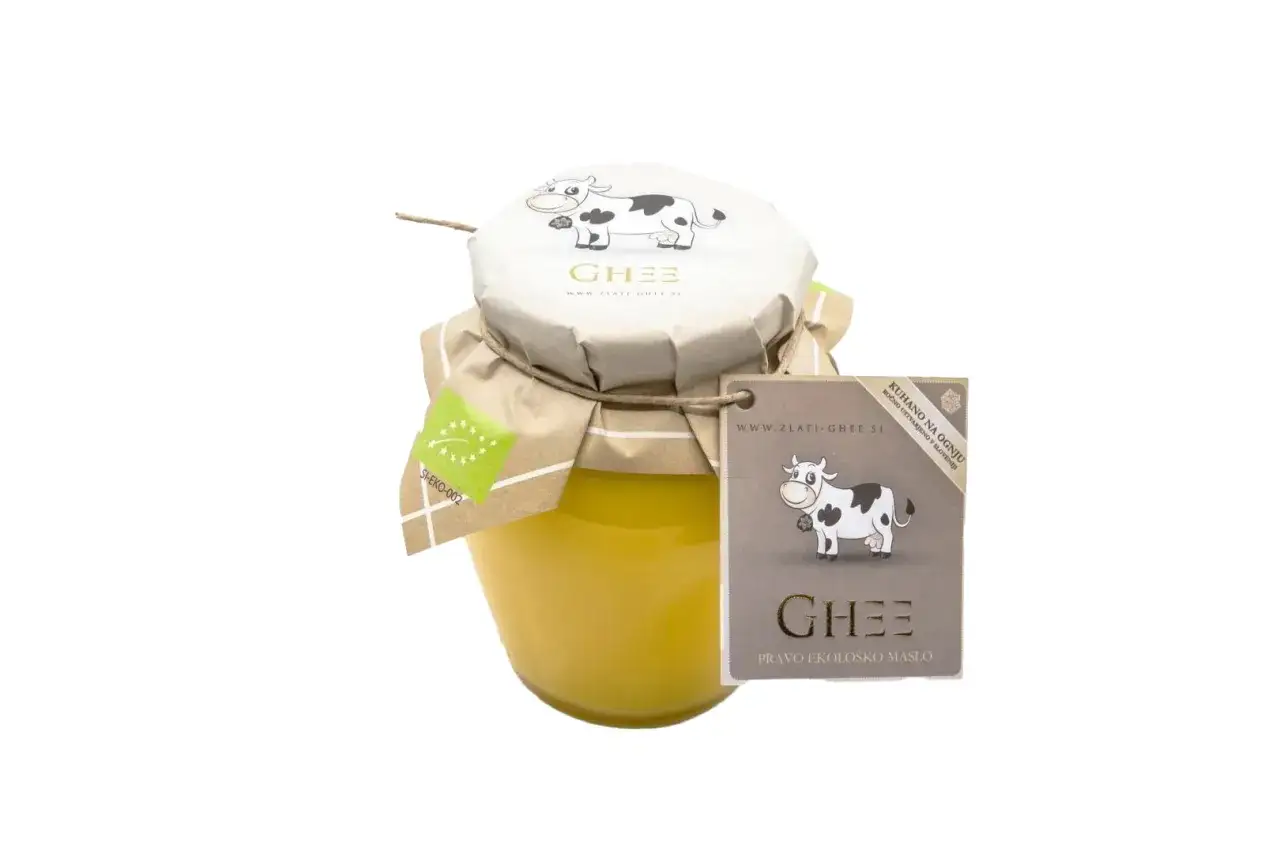 Glasgef&auml;&szlig; mit goldgelbem Ghee-Butter, verziert mit einer Kuh und dem Siegel 