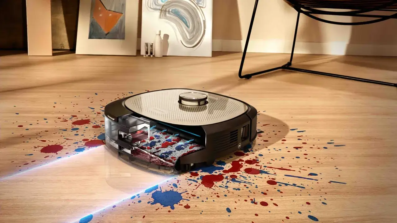 Robot aspirador limpiando manchas de pintura roja y azul. ¡Ahora entiendo porque mi conga no friega!