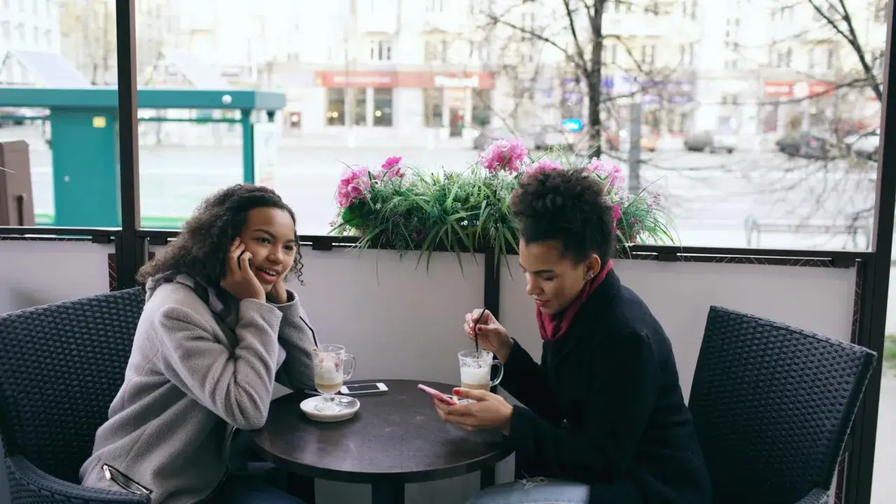 Dwie dziewczyny siedzą przy stoliku w kawiarni. Jedna rozmawia przez telefon, druga przegląda coś na smartfonie. Czas na pytania do nowo poznanej osoby.