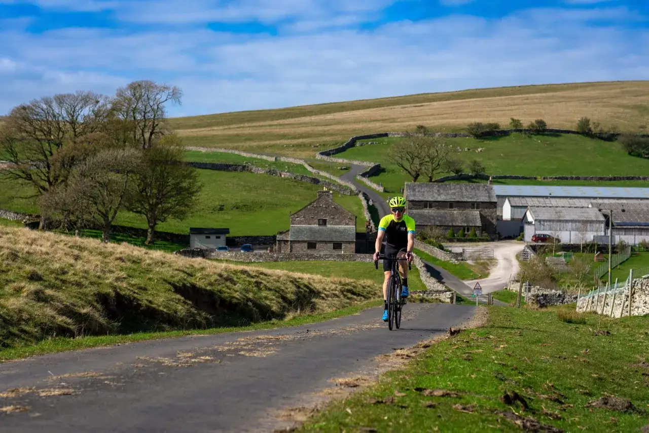 Cyclist enjoying a scenic ride through the rolling hills of England, perfect for England bike tours.
