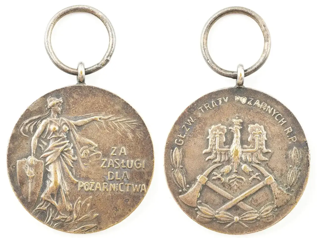 Srebrny medal za zasługi dla pożarnictwa z wizerunkiem bogini i orłem.