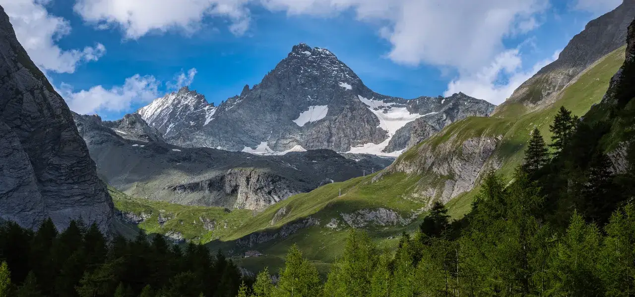 Majestatyczny najwyższy szczyt Austrii, Grossglockner, wznosi się ponad zielonymi dolinami i skalistymi zboczami.