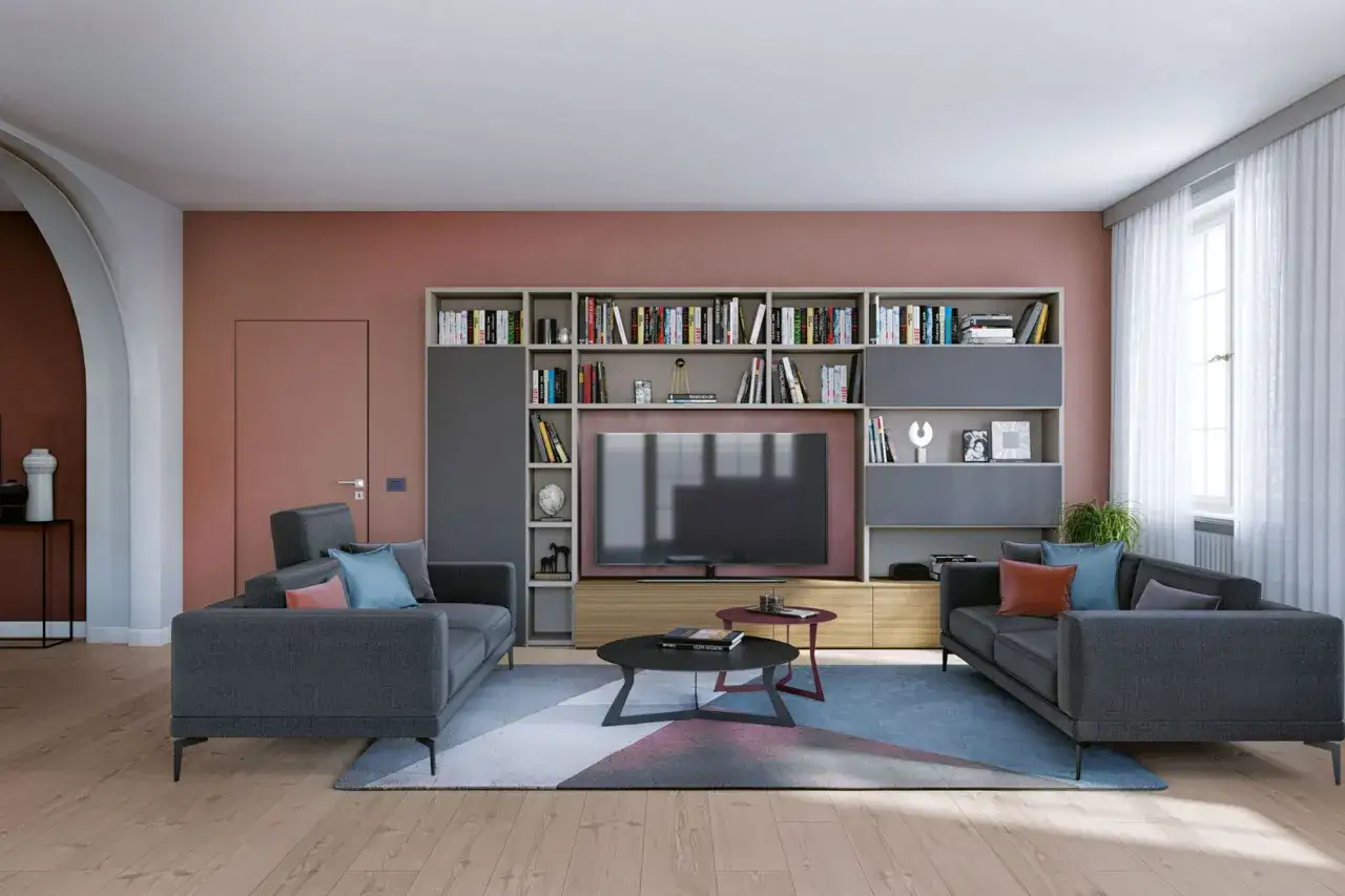 Soggiorno con due divani grigi, libreria a muro e TV. Un tappeto geometrico completa lo stile casa moderno.