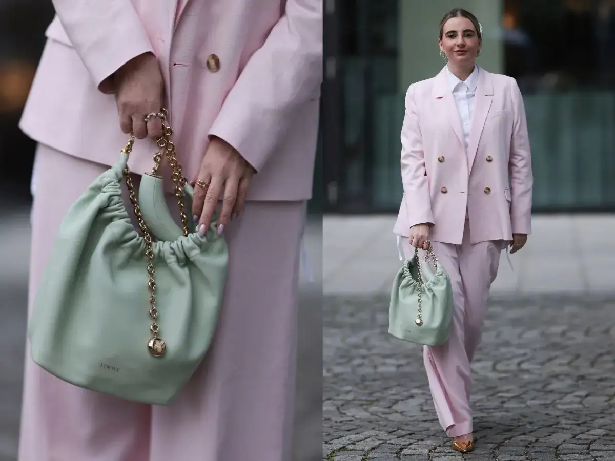 Elegancka stylizacja na chrzest dla matki: pudrowy różowy garnitur, biała koszula i miętowa torebka.
