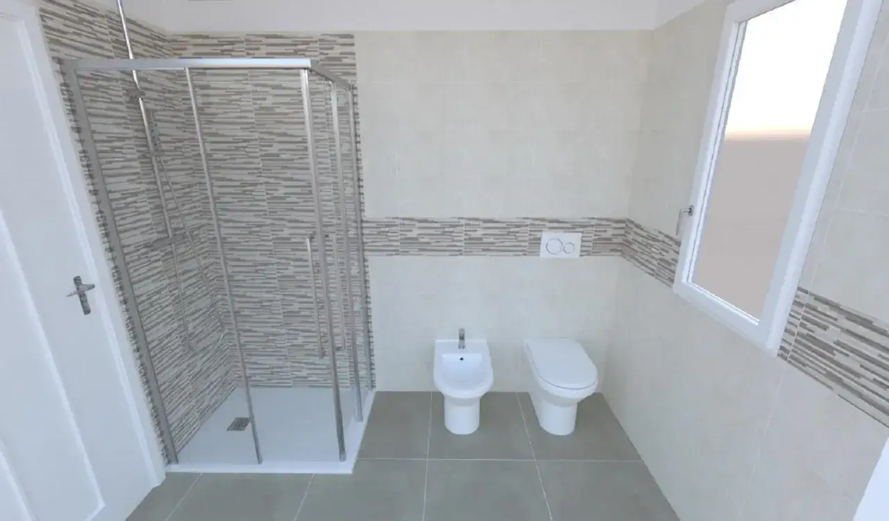 Bagno moderno con doccia, wc e bidet. Un piccolo muretto dietro wc e bidet separa gli elementi.