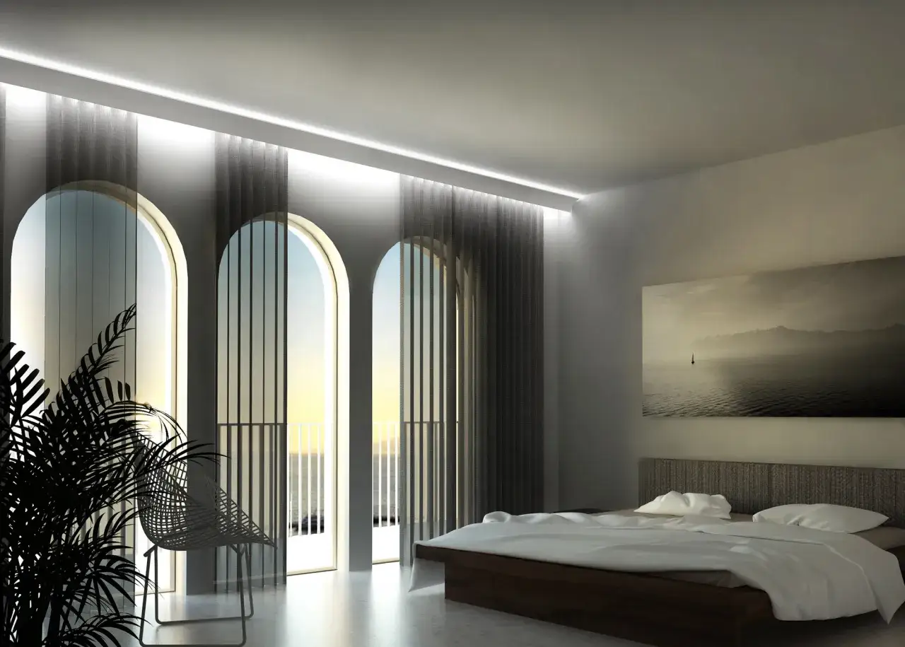 Camera da letto moderna con letto matrimoniale, quadri astratti e finestre ad arco che si affacciano sul mare. Ideale per chi cerca come fare una veletta in cartongesso.