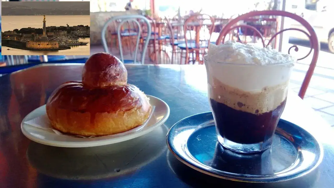 Brioche e granita al caff&egrave;, un classico siciliano, con vista sul mare e monumento.