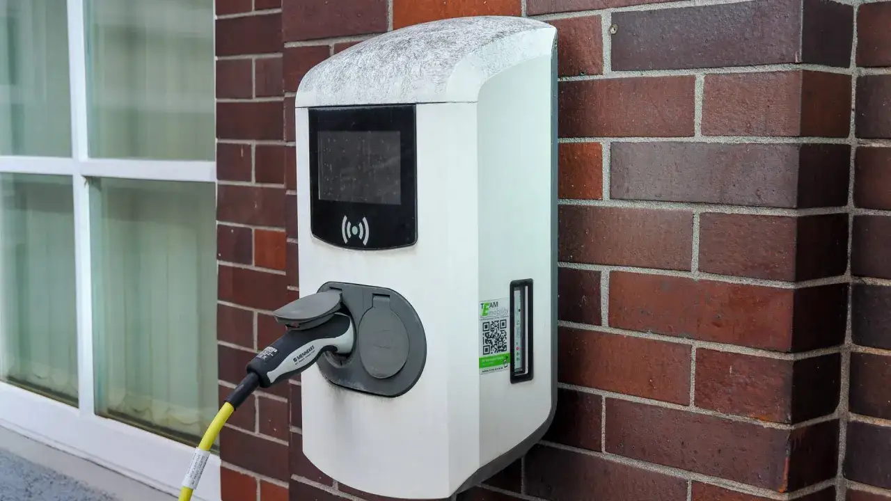 Wallbox-Ladestation an einer Ziegelwand, die Kosten für Elektroautos.
